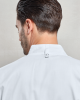 Бяла професионална шефска куртка с цип, къс ръкав и двойни джобове за химикалки на ръкава.